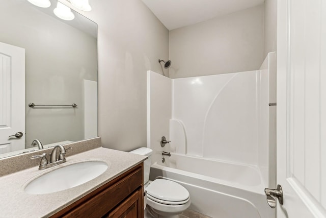 bathroom featuring vanity, bathing tub / shower combination, and toilet