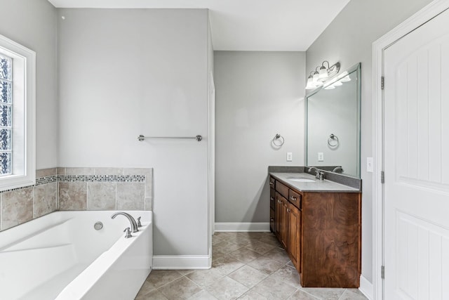 full bathroom featuring a bath, tile patterned flooring, a healthy amount of sunlight, and vanity