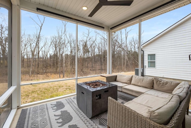 sunroom / solarium featuring plenty of natural light and a ceiling fan