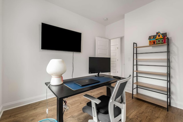 office space with wood finished floors and baseboards