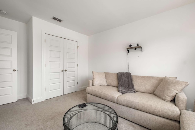 living room featuring baseboards, visible vents, and carpet floors