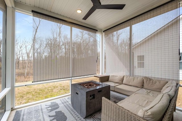 sunroom with wood ceiling and a ceiling fan