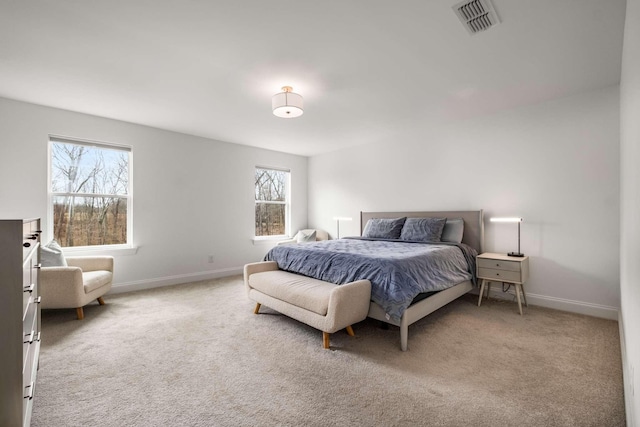 carpeted bedroom featuring visible vents and baseboards