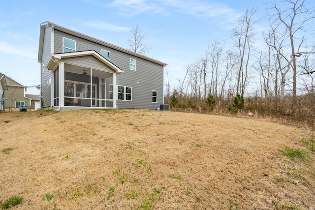 back of house with cooling unit, a yard, and a sunroom