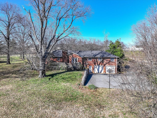 view of yard featuring driveway and an attached garage