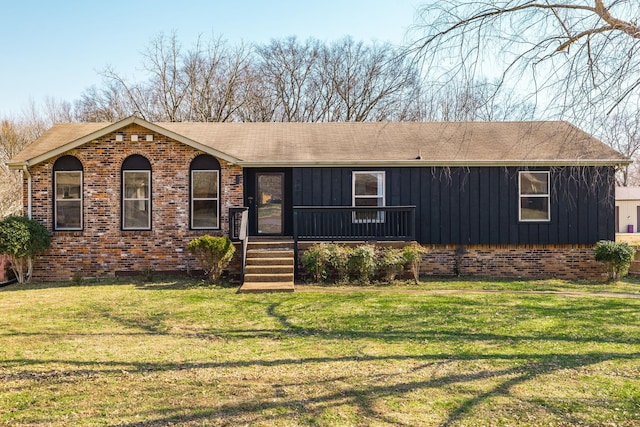 view of front of home featuring brick siding, board and batten siding, and a front lawn