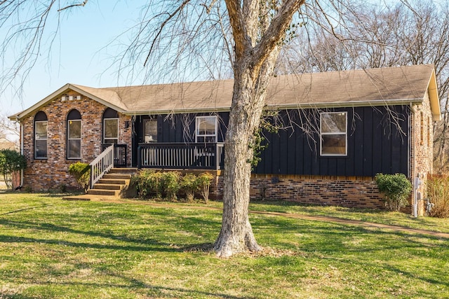 ranch-style home with brick siding, board and batten siding, and a front yard