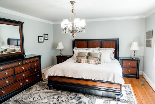 bedroom featuring light wood-style flooring, an inviting chandelier, baseboards, and ornamental molding