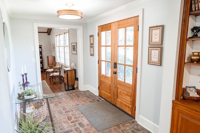 doorway to outside with brick floor, french doors, baseboards, and ornamental molding