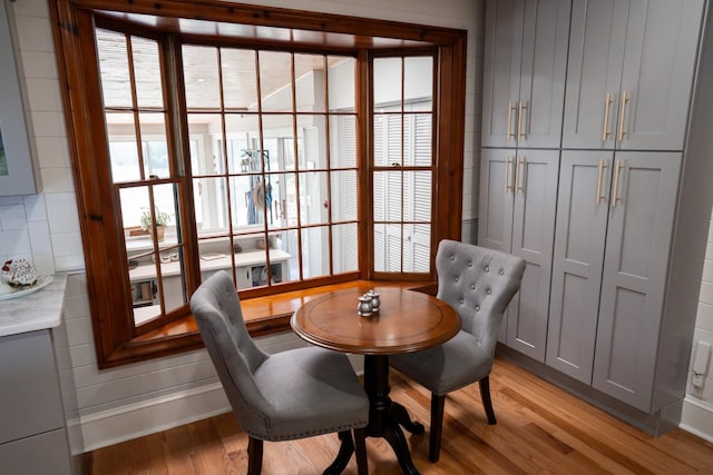 dining space with light wood-style flooring and baseboards