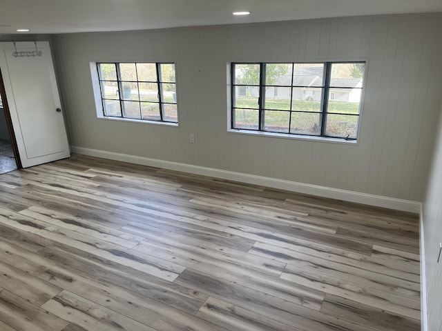 unfurnished room featuring recessed lighting, baseboards, and wood finished floors