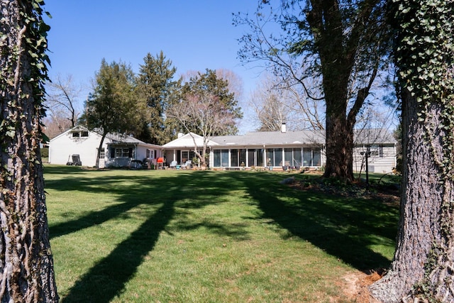 view of yard with a sunroom