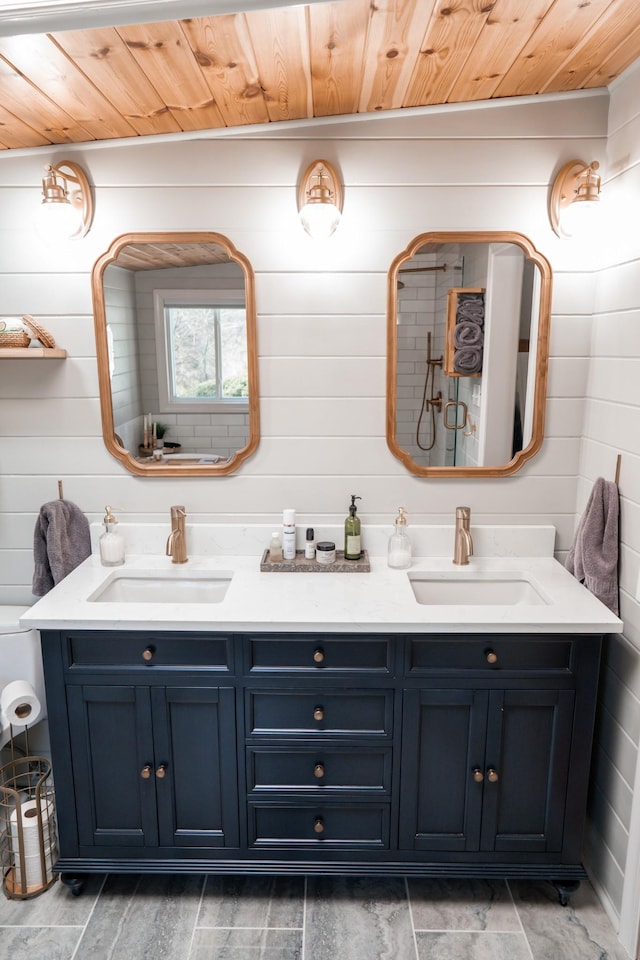 bathroom with double vanity, wooden ceiling, and a sink