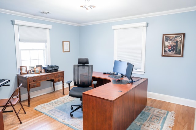 office area featuring crown molding, baseboards, visible vents, and light wood-type flooring