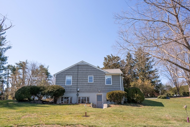 view of property exterior with a yard