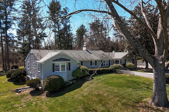 single story home with a front lawn and a chimney