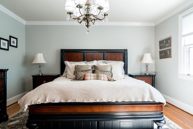 bedroom featuring crown molding, wood finished floors, and baseboards