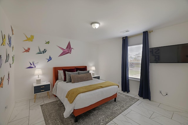 bedroom featuring visible vents, marble finish floor, and baseboards