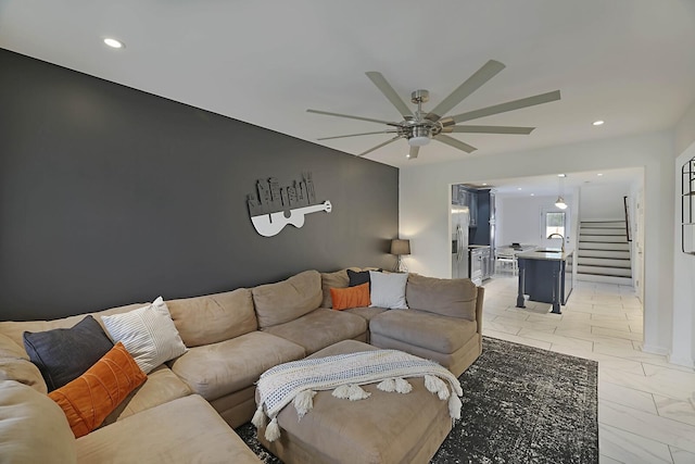 living room with recessed lighting, stairs, and ceiling fan