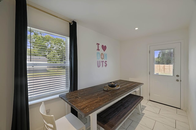 dining room with a wealth of natural light, marble finish floor, and recessed lighting