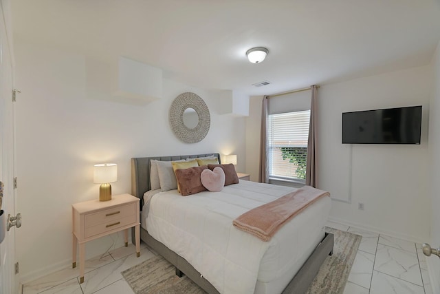 bedroom featuring visible vents, marble finish floor, and baseboards