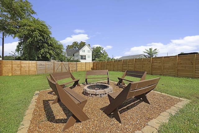 view of yard featuring a fire pit and a fenced backyard