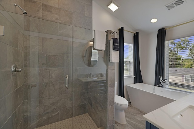 full bathroom featuring visible vents, lofted ceiling, a stall shower, a soaking tub, and vanity