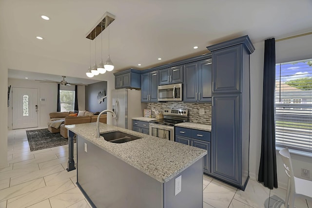 kitchen featuring a sink, stainless steel appliances, marble finish floor, and open floor plan