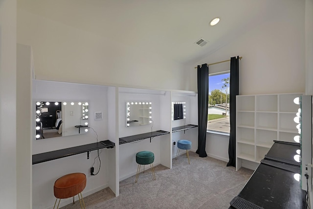 carpeted home office featuring visible vents, baseboards, and vaulted ceiling