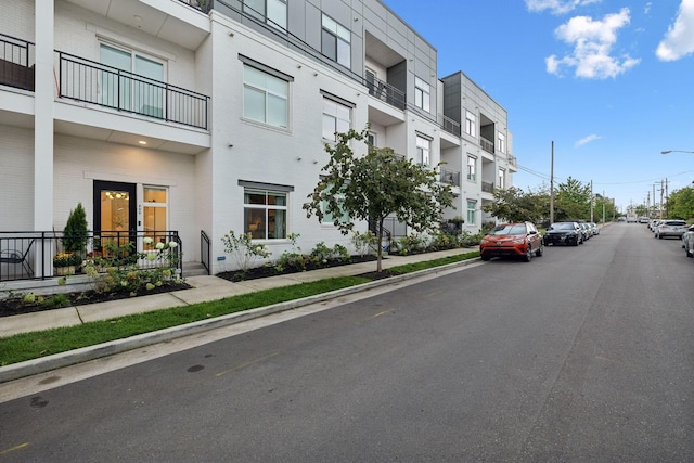 view of street featuring curbs, street lights, and sidewalks