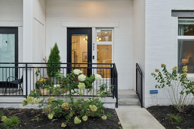 entrance to property featuring brick siding