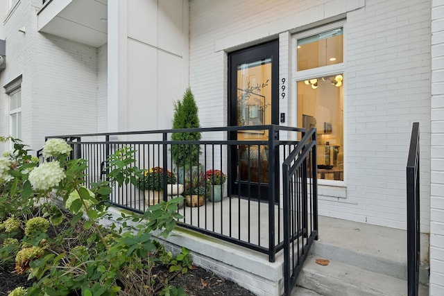 property entrance featuring brick siding