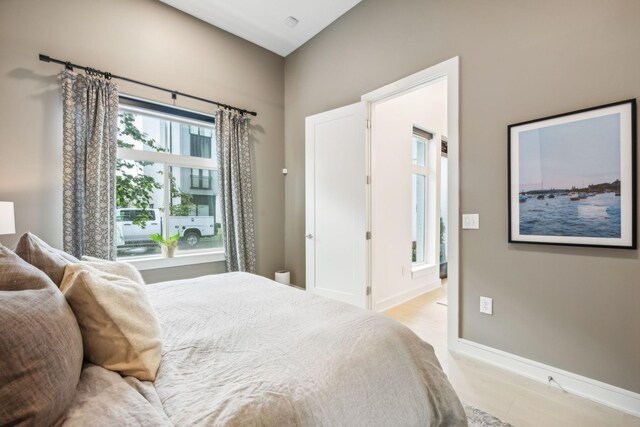 bedroom with light wood-style flooring and baseboards