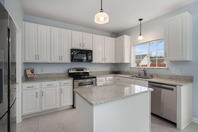 kitchen with white cabinets, appliances with stainless steel finishes, pendant lighting, and a sink