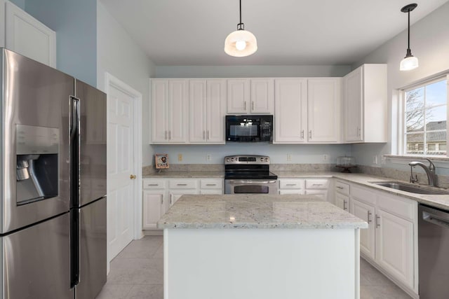 kitchen featuring white cabinets, light tile patterned flooring, appliances with stainless steel finishes, and a sink