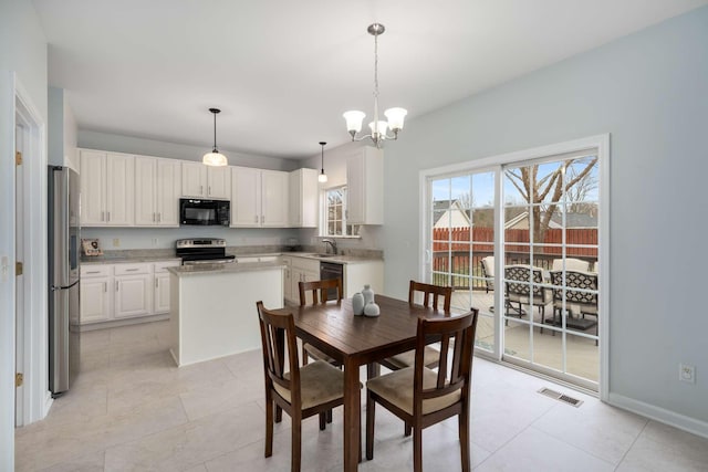 dining space featuring light tile patterned floors, visible vents, baseboards, and an inviting chandelier