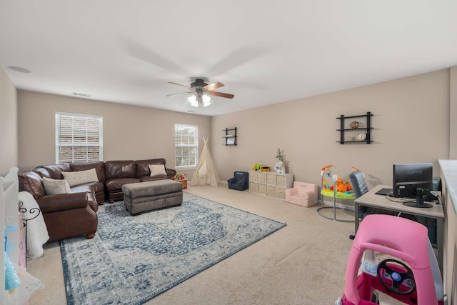 carpeted living area featuring a ceiling fan and visible vents