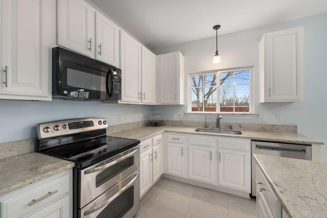 kitchen featuring light tile patterned floors, white cabinets, appliances with stainless steel finishes, and a sink