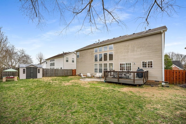 rear view of house featuring an outbuilding, crawl space, a storage unit, and a fenced backyard