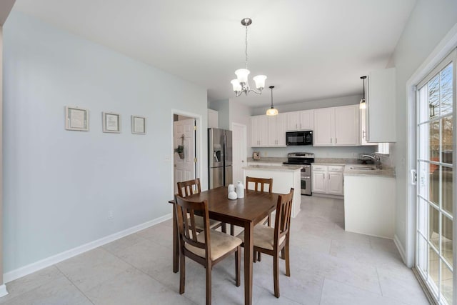 dining area with baseboards and a chandelier