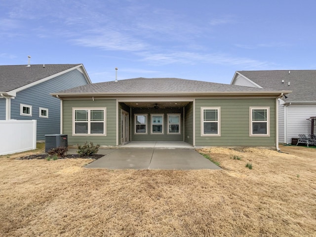 back of property featuring central air condition unit, roof with shingles, a patio, and fence