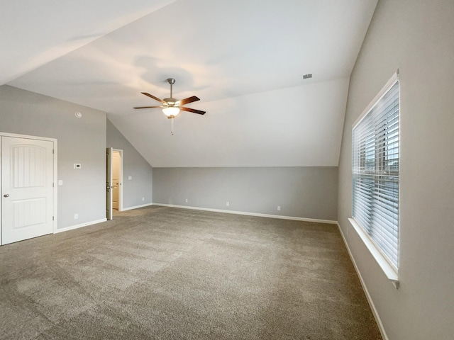 additional living space with visible vents, a ceiling fan, lofted ceiling, and baseboards