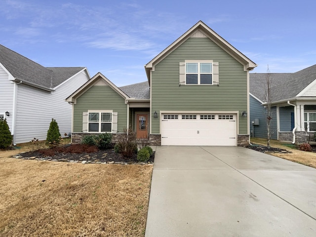 craftsman inspired home featuring stone siding, an attached garage, and driveway