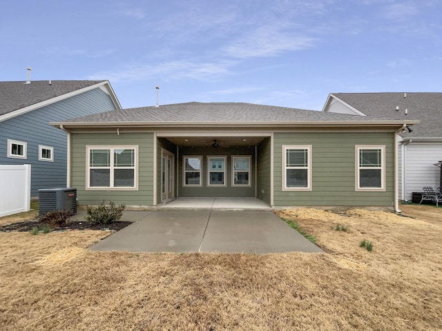 back of property with a patio area, cooling unit, and a shingled roof