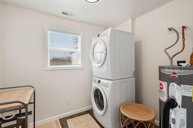 753 Theta Pike, Columbia, TN 38401 - clothes washing area featuring baseboards, visible vents, stacked washing maching and dryer, laundry area, and water heater
