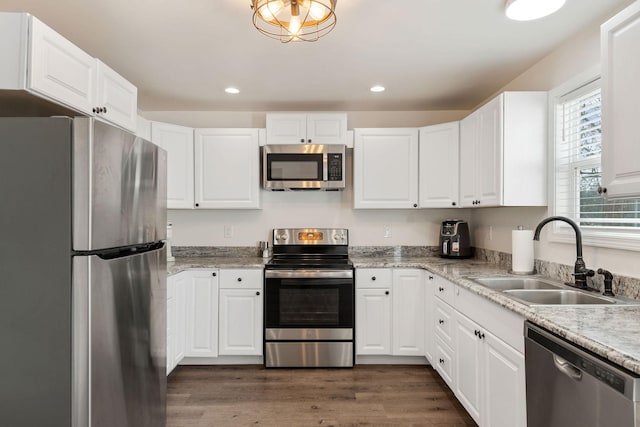 753 Theta Pike, Columbia, TN 38401 - kitchen with dark wood finished floors, recessed lighting, a sink, appliances with stainless steel finishes, and white cabinetry