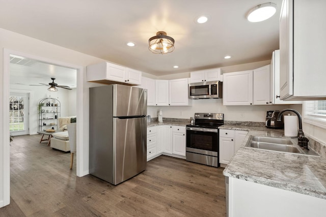 753 Theta Pike, Columbia, TN 38401 - kitchen featuring a sink, dark wood-type flooring, appliances with stainless steel finishes, and white cabinetry