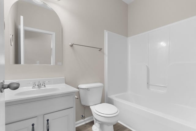 bathroom featuring toilet, wood finished floors, and vanity