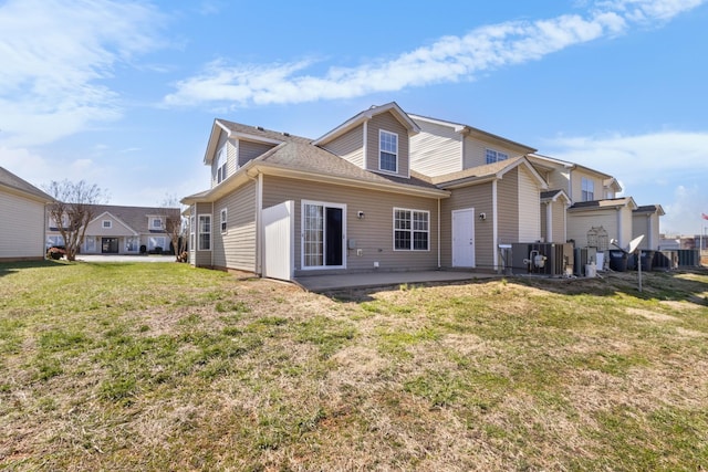 rear view of property featuring a patio area and a yard