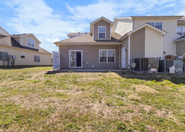 back of house featuring a patio, central air condition unit, and a yard